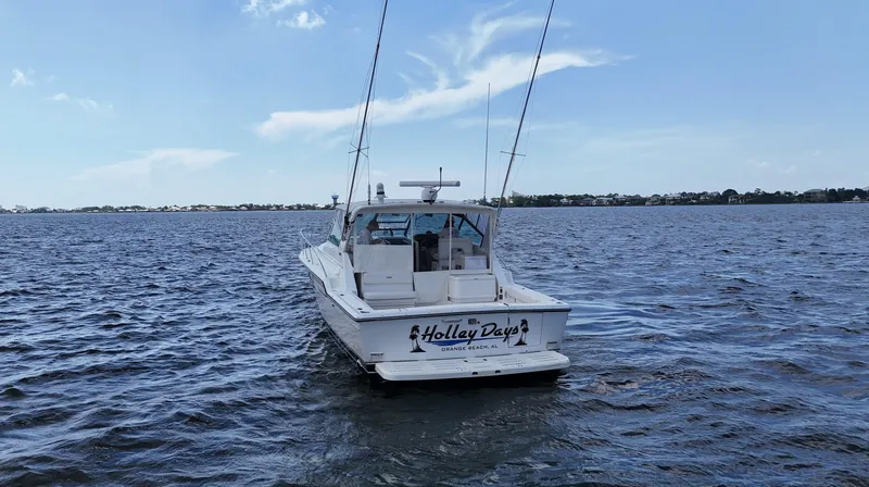 Slide: The Image of 2000 Tiara Yachts 3700 Open on water, rear view, clear sky. - 3