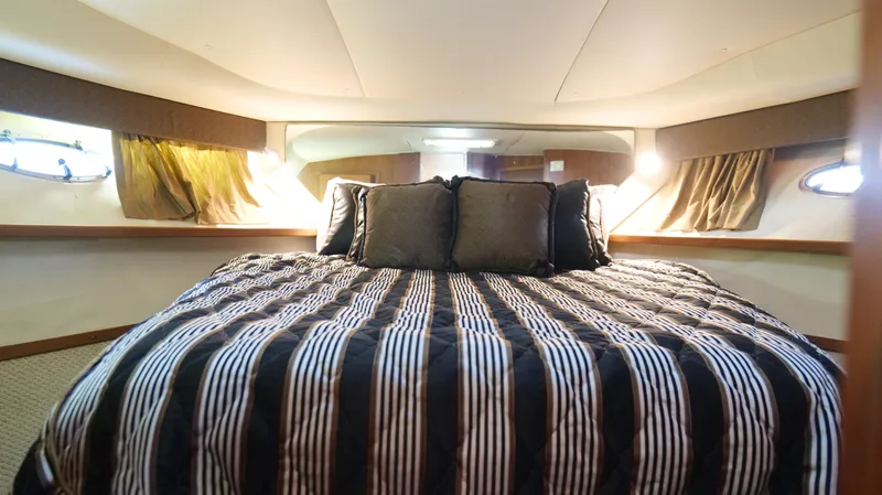 Slide: The Image of Luxurious cabin interior of 2000 Tiara Yachts 3700 Open with striped bedding. - 38