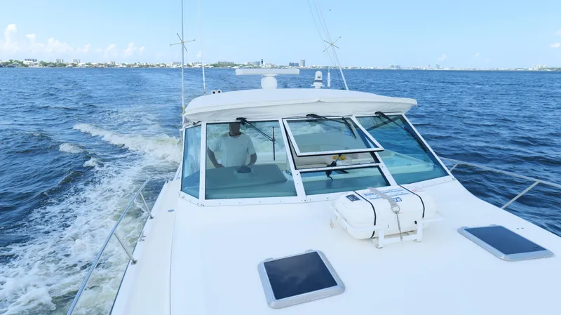 Slide: The Image of 2000 Tiara Yachts 3700 Open cruising on open water, clear sky in background. - 42