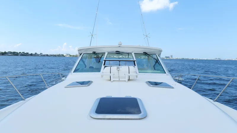 Slide: The Image of Tiara Yachts 3700 Open 2000 model cruising on open water under clear blue sky. - 43