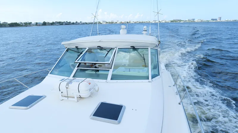 Slide: The Image of 2000 Tiara Yachts 3700 Open cruising on a calm blue sea. - 44