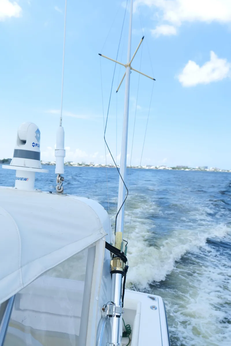 Slide: The Image of 2000 Tiara Yachts 3700 Open cruising on open water under clear blue skies. - 45