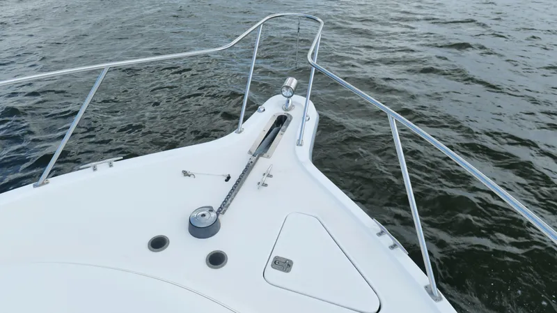 Slide: The Image of Bow of 2000 Tiara Yachts 3700 Open on water, featuring anchor and railing. - 46