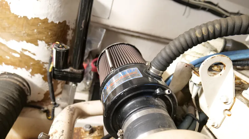 Slide: The Image of Engine compartment of a 2000 Tiara Yachts 3700 Open, featuring a detailed air filter. - 49