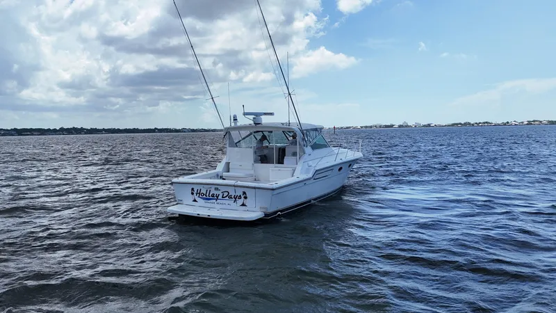 Slide: The Image of 2000 Tiara Yachts 3700 Open boat on open water under a partly cloudy sky. - 5