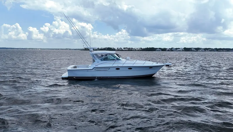 Slide: The Image of 2000 Tiara Yachts 3700 Open cruising on a calm sea under a cloudy sky. - 6