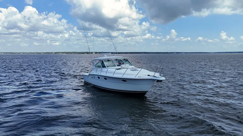 Slide: The Image of 2000 Tiara Yachts 3700 Open cruising on a calm sea under a partly cloudy sky. - 7