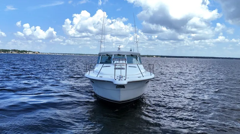 Slide: The Image of 2000 Tiara Yachts 3700 Open on calm water under a partly cloudy sky. - 8