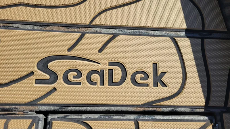 Slide: The Image of SeaDek logo on textured surface, featured on Xpress X23B Bay boat, 2026 model. - 11