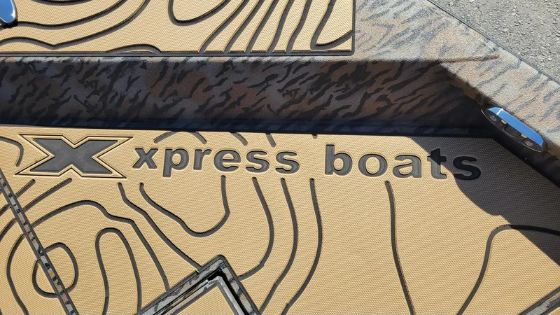 Slide: The Image of Xpress Boats logo on patterned deck, X23B Bay model, 2026. - 12