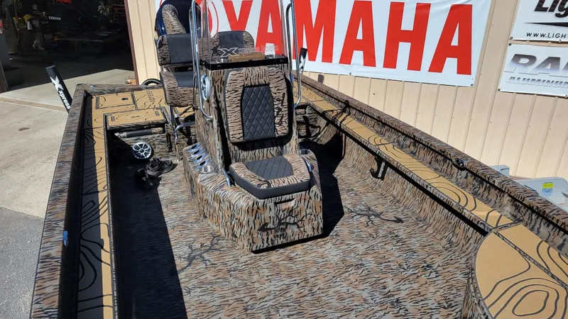Slide: The Image of 2026 Xpress X23B Bay boat with camo design, Yamaha Vmax 250 SHO, displayed outdoors. - 14
