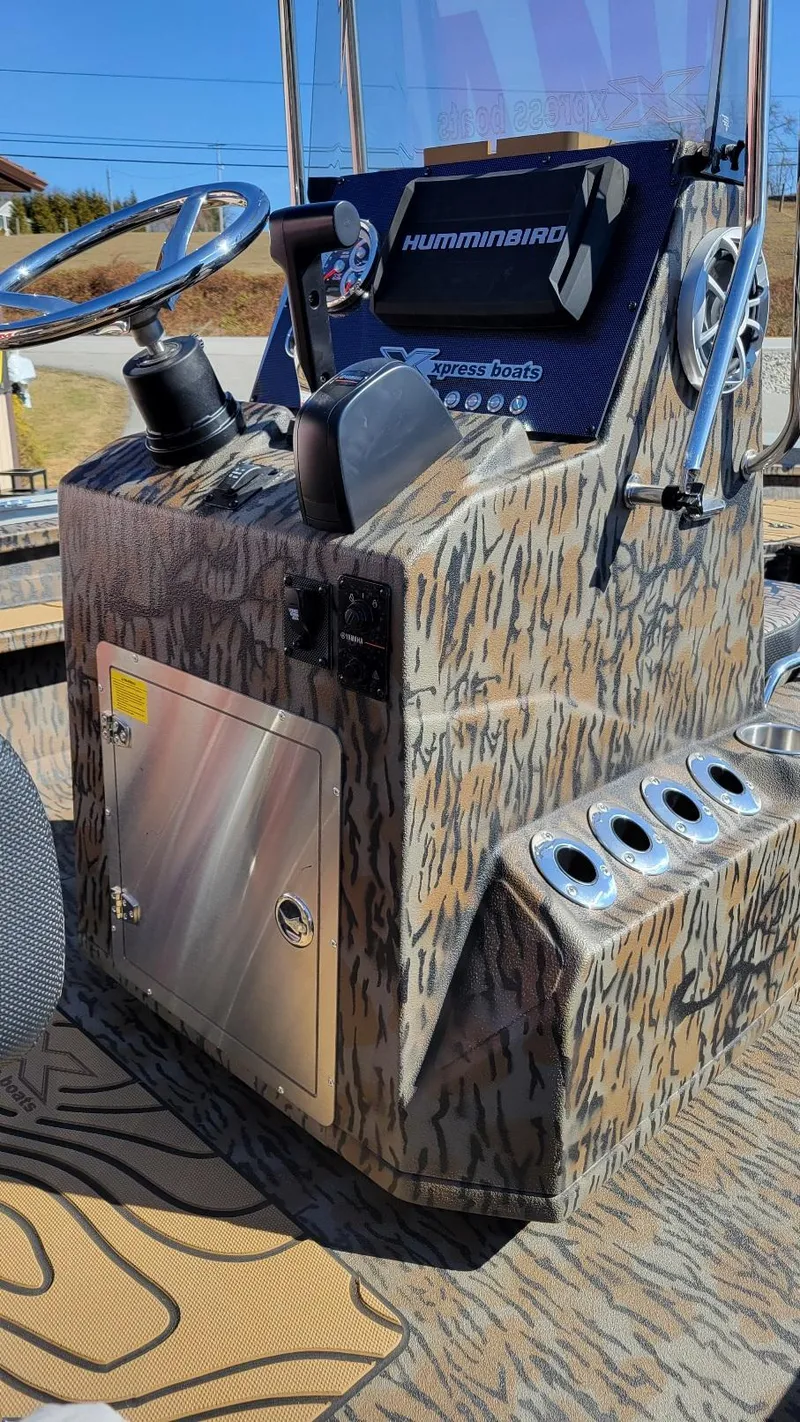 Slide: The Image of Center console of 2026 Xpress X23B Bay boat with camo design and Humminbird electronics. - 17