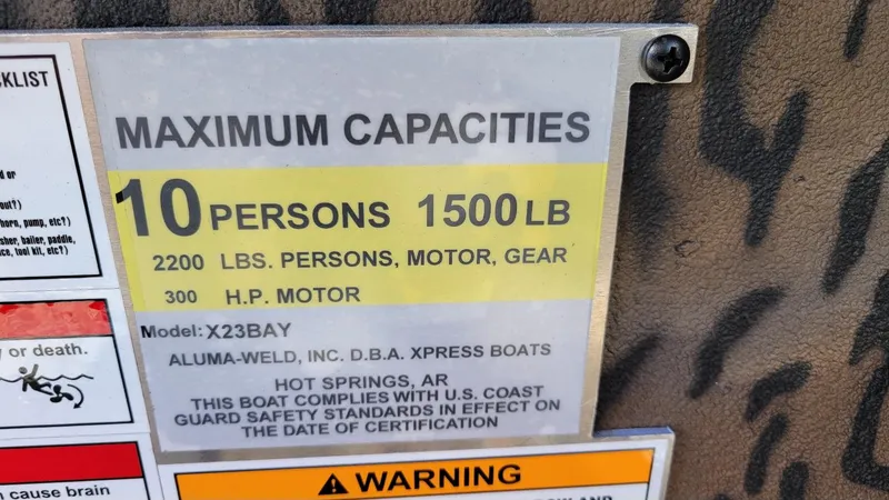 Slide: The Image of Boat capacity label: 10 persons, 1500 lbs, 300 HP motor, Xpress X23B Bay. - 18