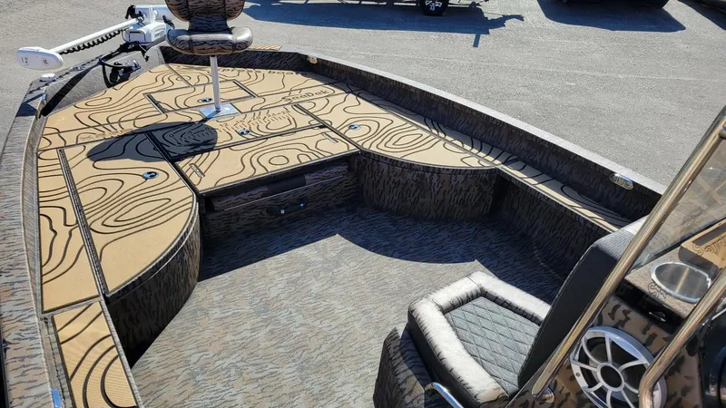 Slide: The Image of 2026 Xpress X23B Bay boat interior with patterned flooring and seating. - 8