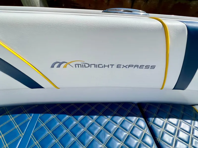 Slide: The Image of Luxury seating on 2022 Midnight Express 37 Open boat, featuring stylish blue and white upholstery. - 11