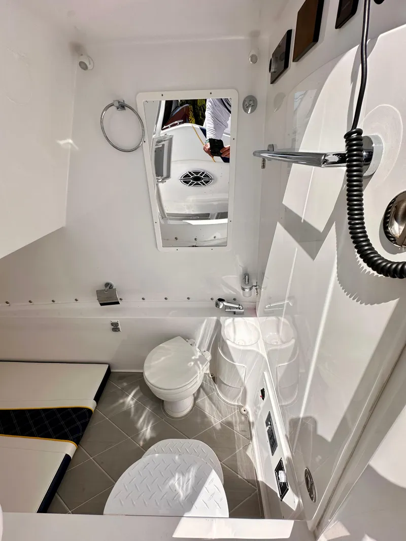 Slide: The Image of Luxurious seating on 2022 Midnight Express 37 Open boat, featuring blue and white upholstery. - 13