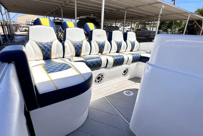 Slide: The Image of Luxurious seating on 2022 Midnight Express 37 Open boat, featuring blue and yellow accents. - 18