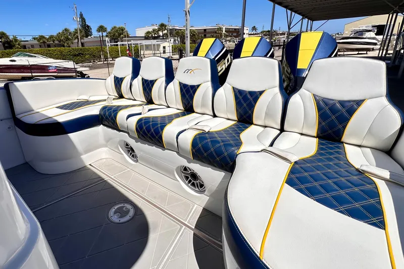 Slide: The Image of Luxurious seating on 2022 Midnight Express 37 Open boat with blue and yellow accents. - 19