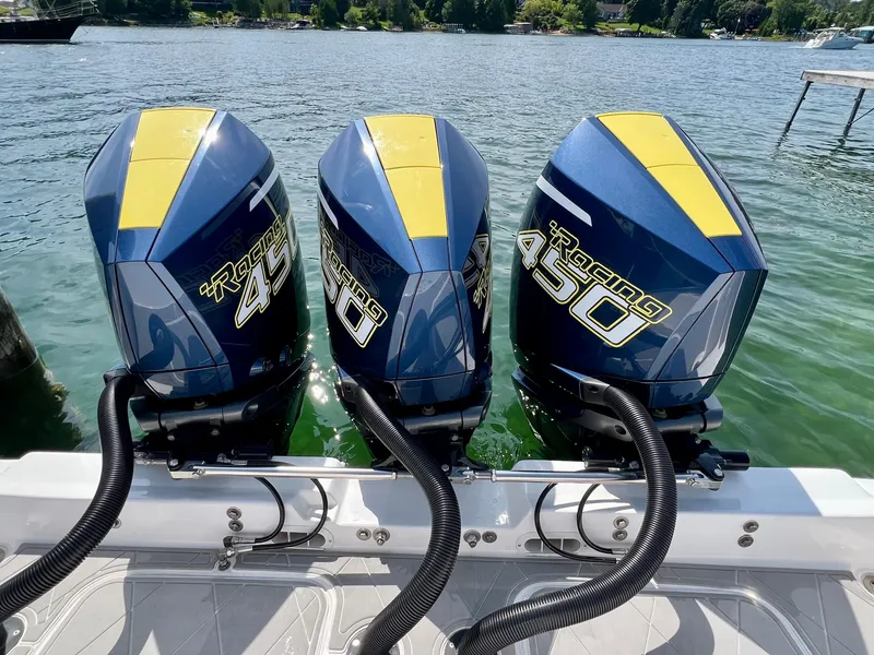 Slide: The Image of 2022 Midnight Express 37 Open boat on trailer under clear blue sky. - 2