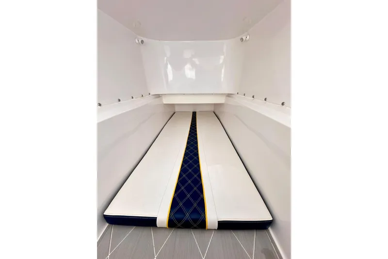 Slide: The Image of 2022 Midnight Express 37 Open cabin interior with sleek white and blue cushioned seating. - 23