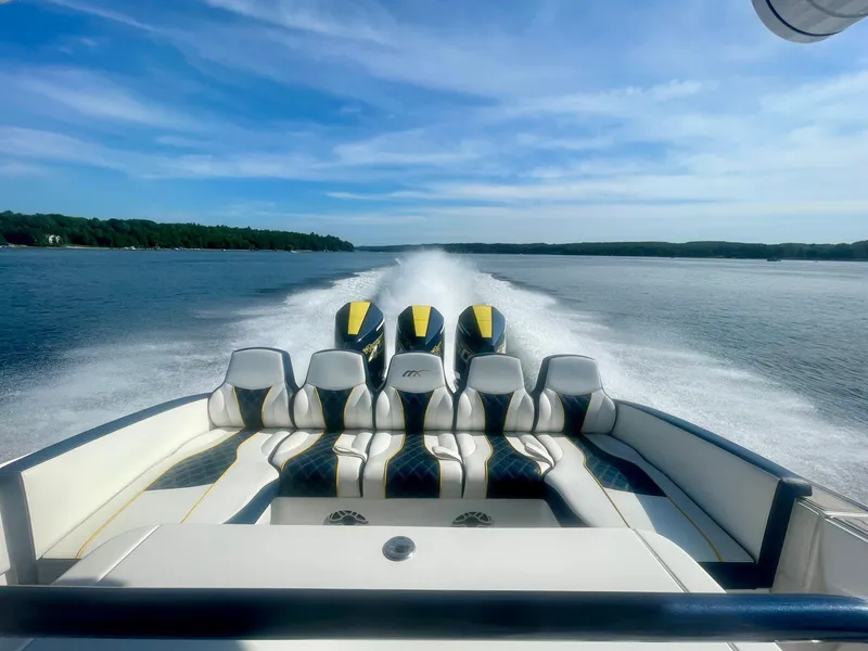 Slide: The Image of 2022 Midnight Express 37 Open boat cruising on a sunny day, showcasing powerful engines. - 24