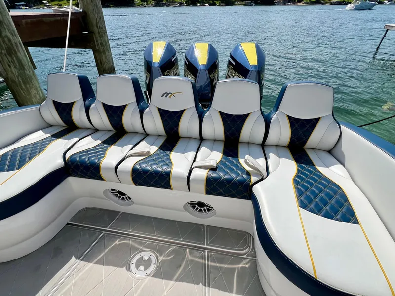 Slide: The Image of 2022 Midnight Express 37 Open boat on a Continental trailer under clear blue sky. - 3