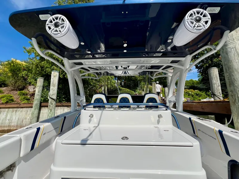 Slide: The Image of 2022 Midnight Express 37 Open boat on trailer under clear blue sky. - 6