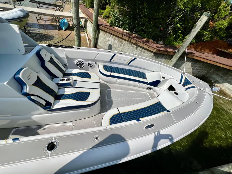 Slide: The Image of 2022 Midnight Express 37 Open boat on trailer under clear blue sky. - 8