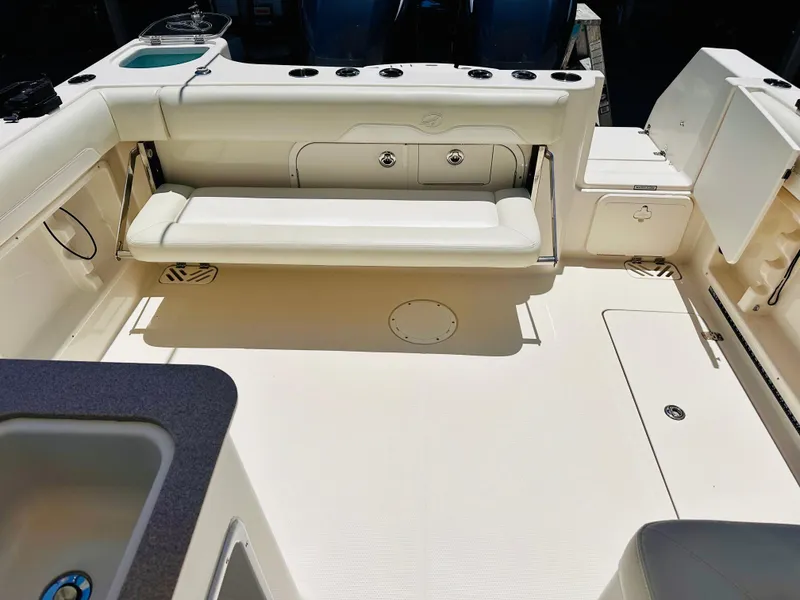 Slide: The Image of 2014 Sailfish 275 DC boat interior with seating and storage compartments. - 10