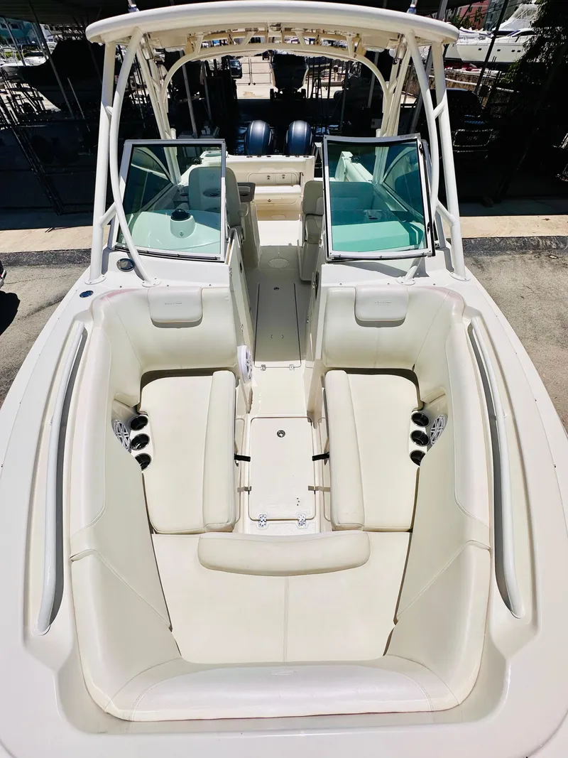 Slide: The Image of 2014 Sailfish 275 DC boat interior with white seating and dual consoles. - 22