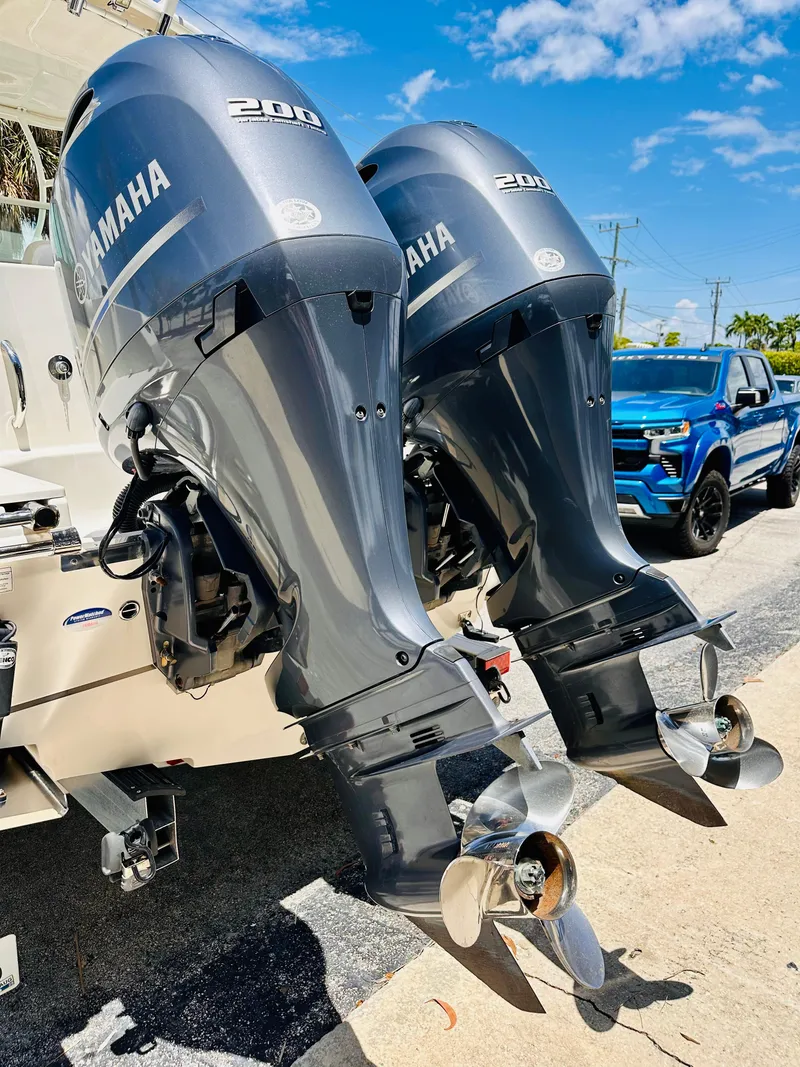 Slide: The Image of Twin Yamaha 200 outboard motors on a 2014 Sailfish 275 DC boat, sunny day. - 5