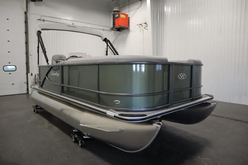 Slide: The Image of 2025 Bentley Pontoons 180 CRUISE LE in a showroom, showcasing sleek design and modern features. - 2