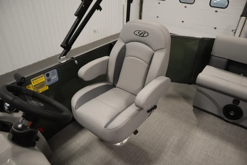 Slide: The Image of 2025 Bentley Pontoons 180 CRUISE LE interior with luxurious captain's chair and steering wheel. - 26