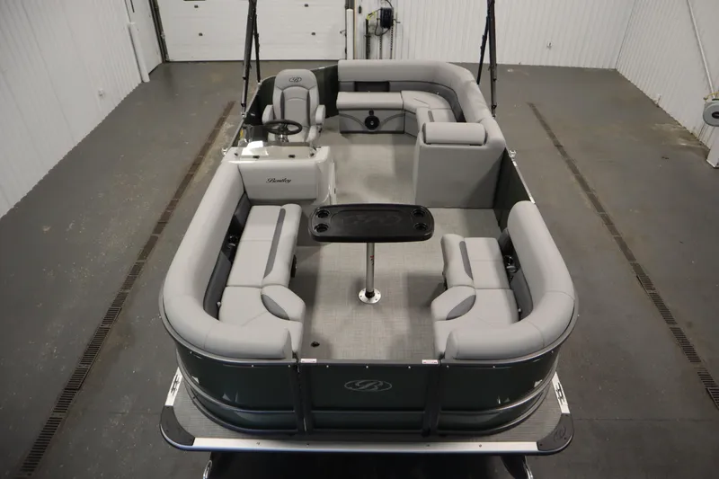 Slide: The Image of 2025 Bentley Pontoons 180 CRUISE LE with spacious seating and sleek design in a showroom. - 8