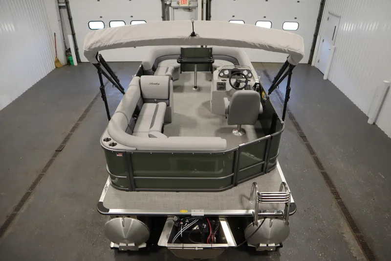 Slide: The Image of 2025 Bentley Pontoons 180 CRUISE LE in a garage, showcasing seating and helm. - 9