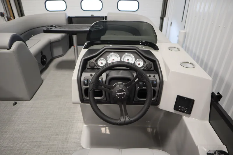 Slide: The Image of 2025 Bentley Pontoons 220 Cruise XL interior with modern steering console and seating. - 16