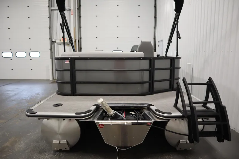 Slide: The Image of 2025 Bentley Pontoons 220 Cruise XL in a showroom, showcasing rear deck and ladder. - 2