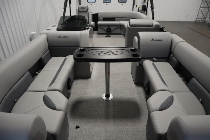 Slide: The Image of 2025 Bentley Pontoons 220 Cruise XL interior with luxurious seating and table setup. - 5