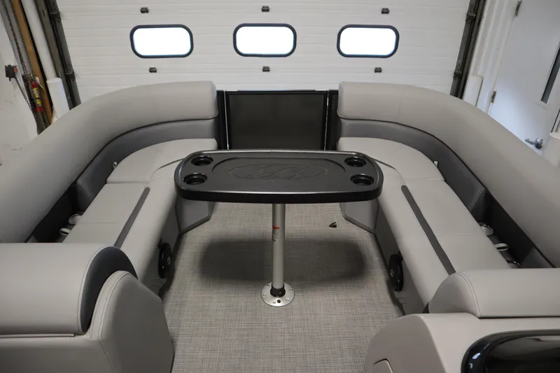 Slide: The Image of 2025 Bentley Pontoons 220 Cruise XL interior with gray seating and central table. - 7