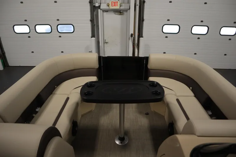 Slide: The Image of 2026 Bentley Pontoons 220 Navigator interior with beige seating and central table. - 10