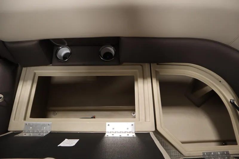 Slide: The Image of 2026 Bentley Pontoons 220 Navigator interior storage compartments, featuring beige and brown design. - 13