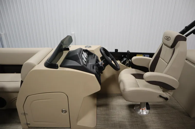 Slide: The Image of 2026 Bentley Pontoons 220 Navigator interior with beige captain's chair and control console. - 17