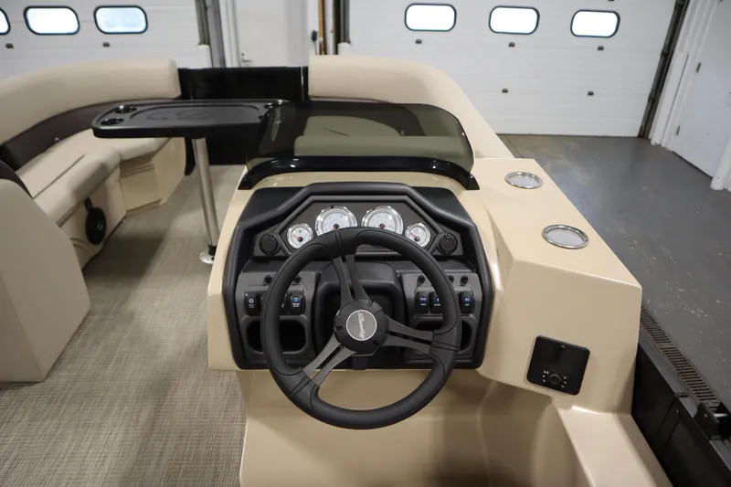 Slide: The Image of 2026 Bentley Pontoons 220 Navigator dashboard with steering wheel and control panel. - 19