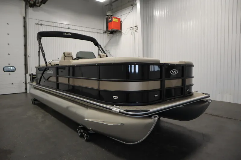 Slide: The Image of 2026 Bentley Pontoons 220 Navigator in a showroom, showcasing sleek design and luxury features. - 2