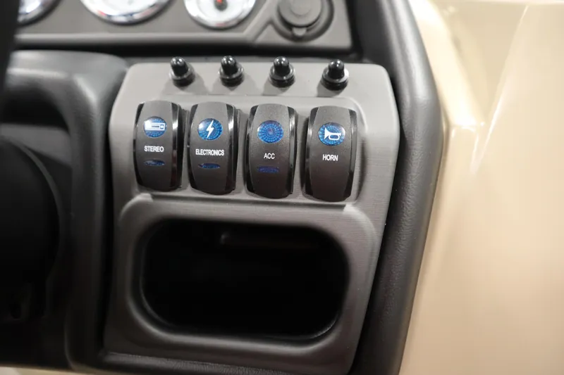 Slide: The Image of Control panel of 2026 Bentley Pontoons 220 Navigator with labeled switches for stereo, electronics, and horn. - 23