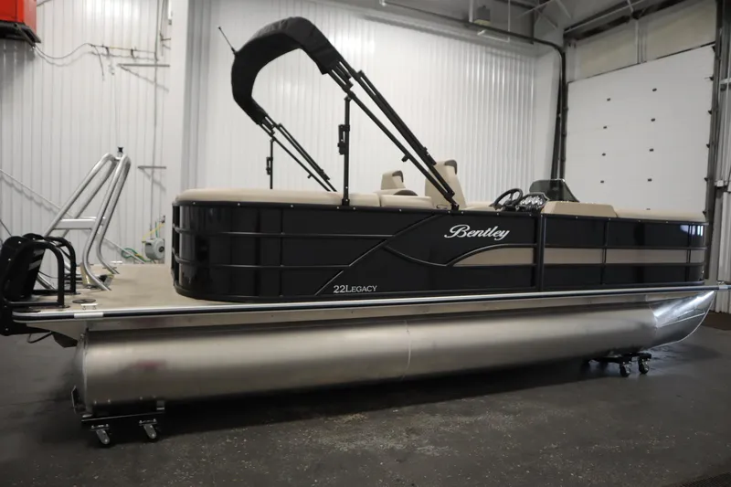 Slide: The Image of 2026 Bentley Pontoons 220 Navigator in a showroom, featuring sleek design and modern amenities. - 3