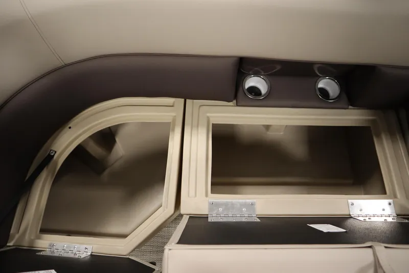 Slide: The Image of 2026 Bentley Pontoons 220 Navigator interior storage compartments, beige and brown design. - 31