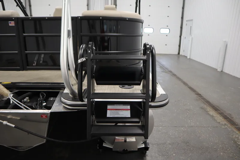 Slide: The Image of 2026 Bentley Pontoons 220 Navigator with rear boarding ladder in a garage setting. - 36