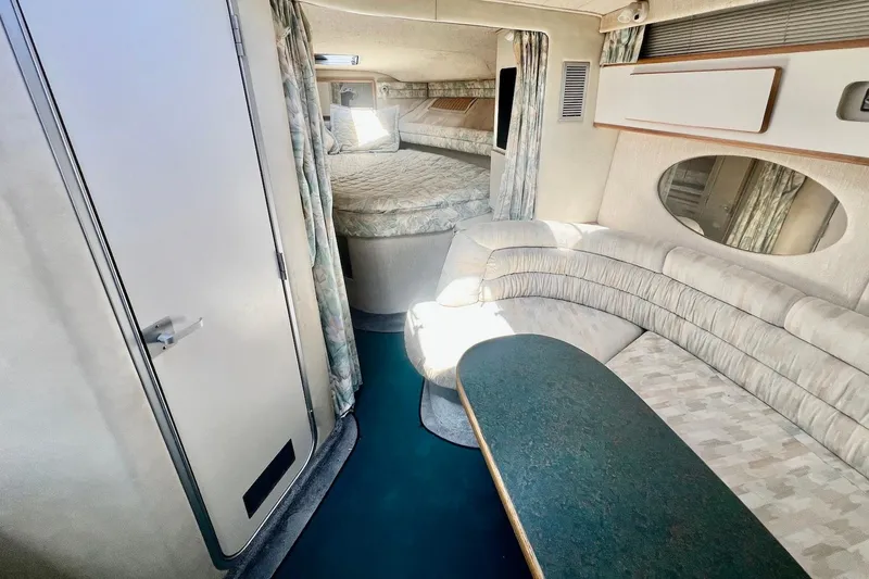 Slide: The Image of Interior of 1993 Sea Ray 370 Sundancer yacht with cozy seating and bed area. - 13