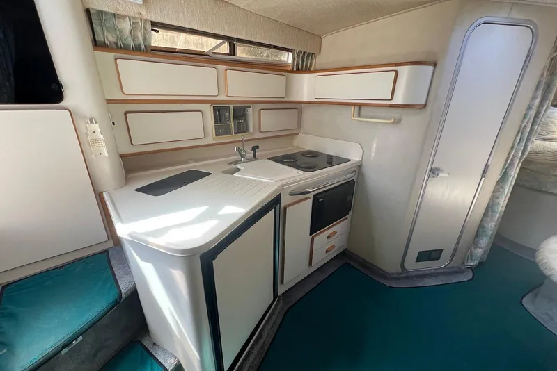 Slide: The Image of Interior of 1993 Sea Ray 370 Sundancer yacht kitchen with stove and cabinets. - 14